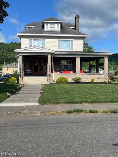 View of front facade featuring a porch and a front yard | Image 1