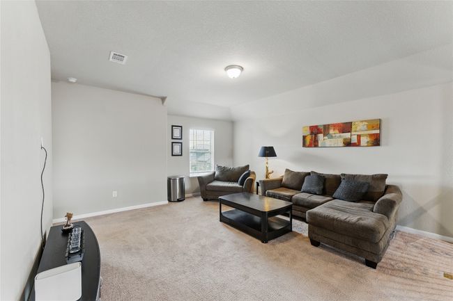 Living room with visible vents, baseboards, and light carpet | Image 26