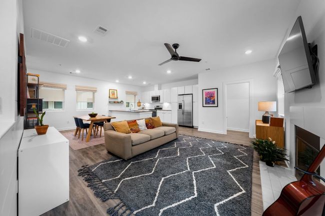Living room with light wood finished floors, visible vents, and recessed lighting | Image 5