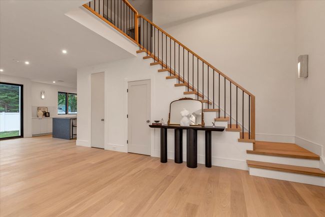 Stairs featuring wood finished floors, recessed lighting, and a towering ceiling | Image 6