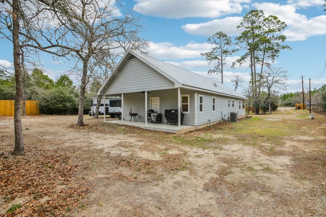 View of side of home featuring central AC unit and a patio area | Image 37