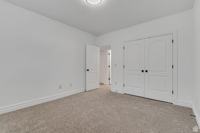 Unfurnished bedroom featuring carpet floors and a closet | Image 36