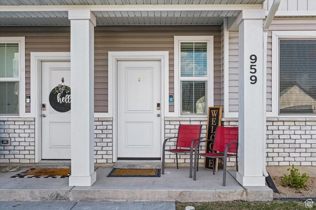 View of exterior entry featuring a porch and stone siding | Image 8