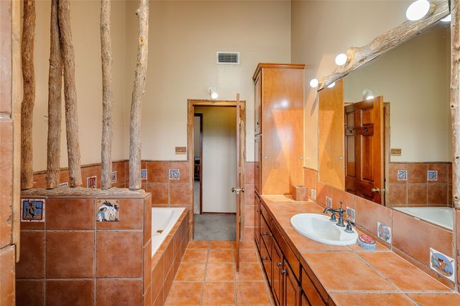 Full bathroom featuring vanity, a garden tub, and tile patterned flooring | Image 15