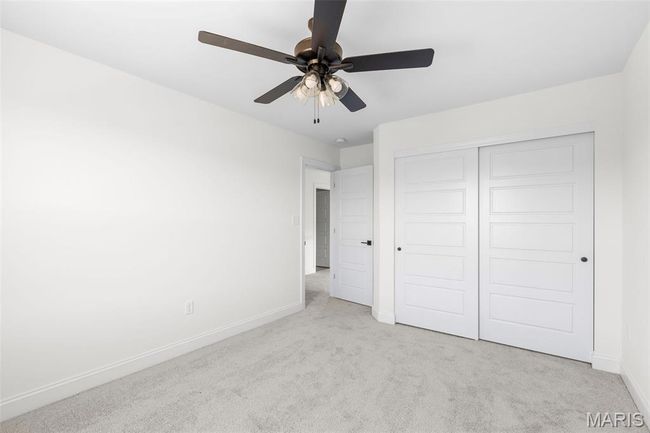 Unfurnished bedroom featuring carpet flooring, a closet, and a ceiling fan | Image 11