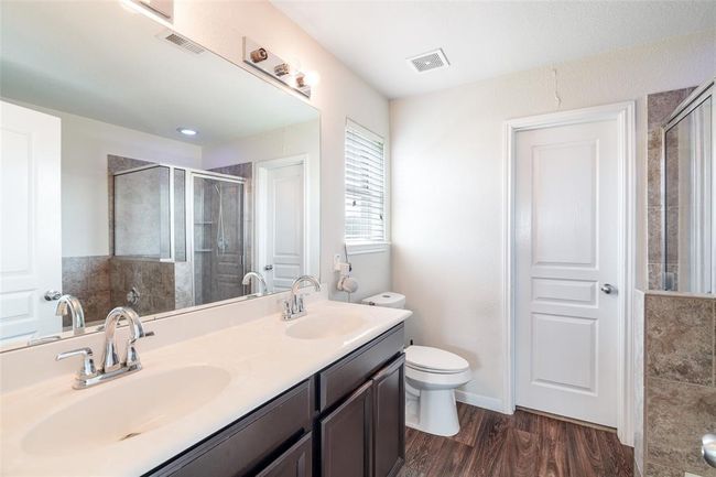 The primary bathroom also boasts a spacious double sink vanity with ample counter space and generous storage, perfectly blending functionality with style. | Image 11