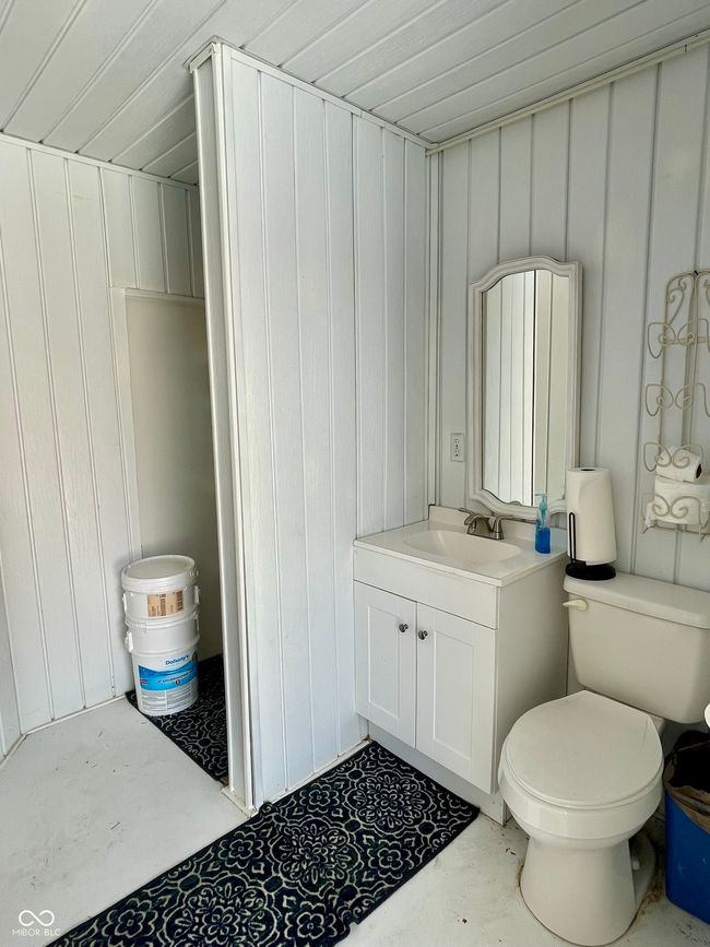 Pool bathroom featuring vanity, toilet and shower | Image 36