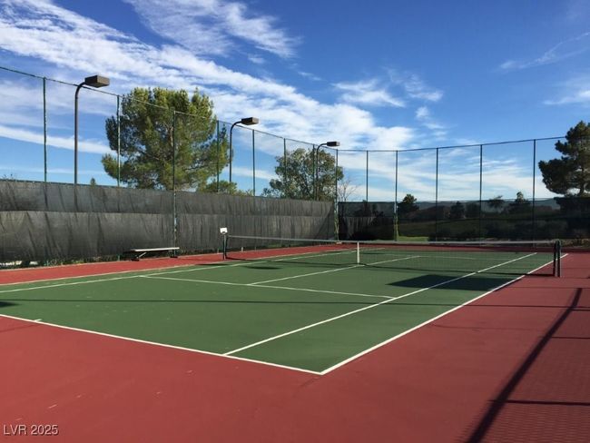 View of tennis court with community basketball court and fence | Image 23