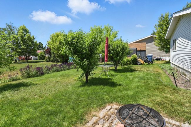 View of green lawn with an outdoor fire pit | Image 23