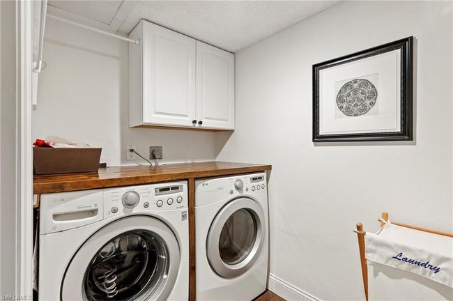 Washroom with separate washer and dryer and cabinet space | Image 18