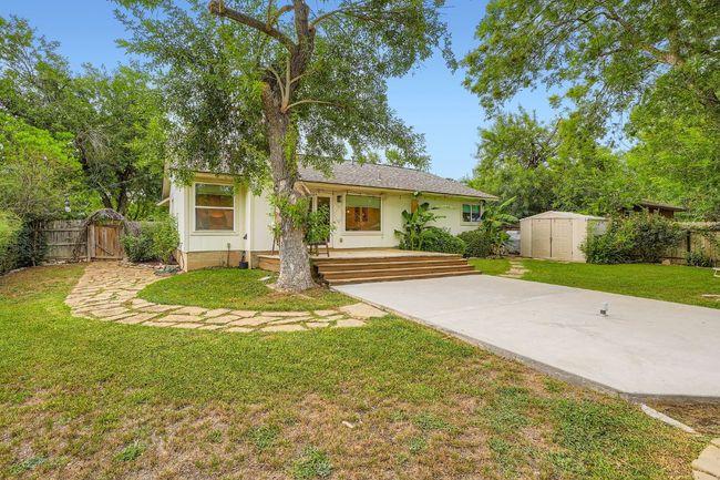 View of front of property featuring a storage unit, a gate, and stucco siding | Image 27