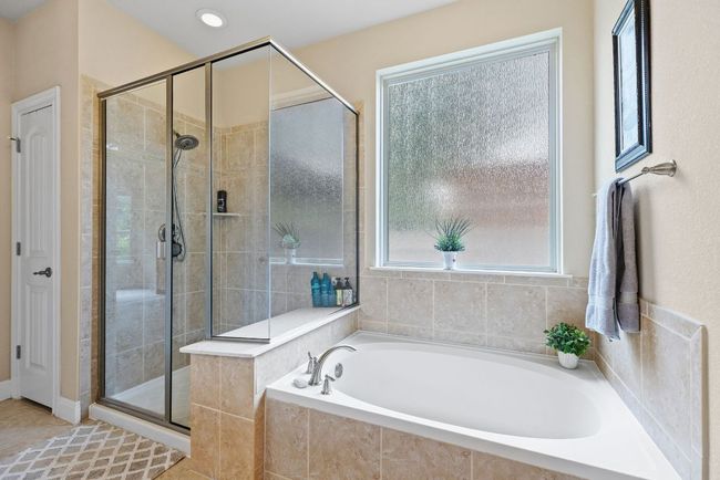 Full bathroom with a garden tub and a shower stall | Image 16