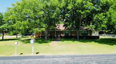 Ranch-style house with a oversized front yard. Pecan trees throughout entire lot. | Image 1