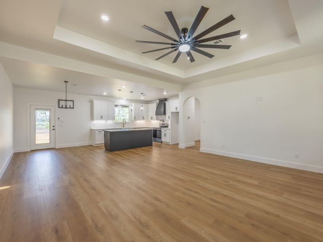 Designed for modern lifestyles, this view highlights the open layout that connects the stylish kitchen, elegant dining area, and comfortable living room—ideal for entertaining or everyday living. | Image 9