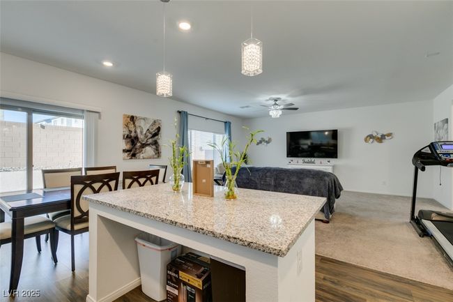 Kitchen with dark wood-style flooring, light stone countertops, a ceiling fan, pendant lighting, and a center​​‌​​​​‌​​‌‌​‌‌​​​‌‌​​‌‌​‌​​​​​‌ island | Image 23