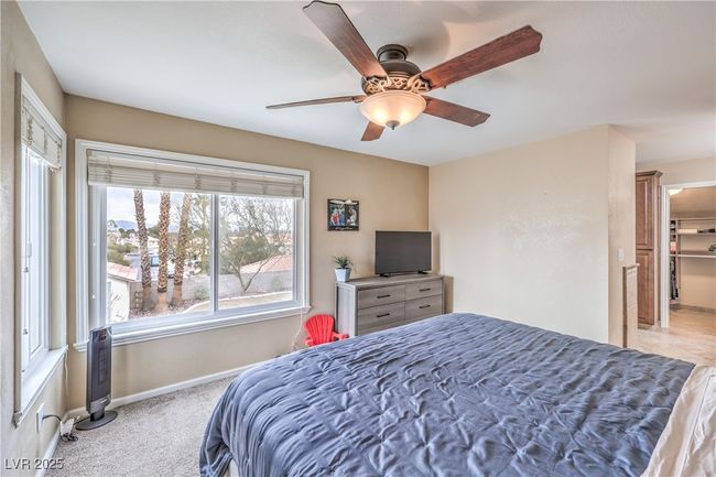 Bedroom featuring a ceiling fan, a spacious closet, carpet, and baseboards | Image 28
