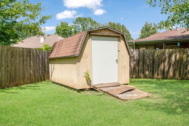 View of shed with a fenced backyard | Image 12