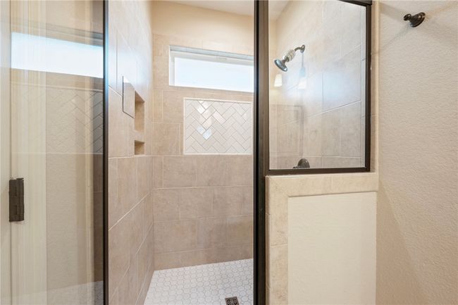 Full bathroom with a stall shower and a textured wall | Image 14