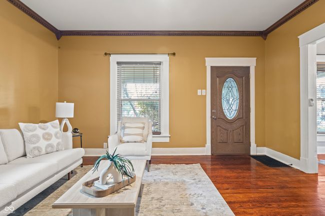 entryway with crown molding and dark wood finished floors | Image 10