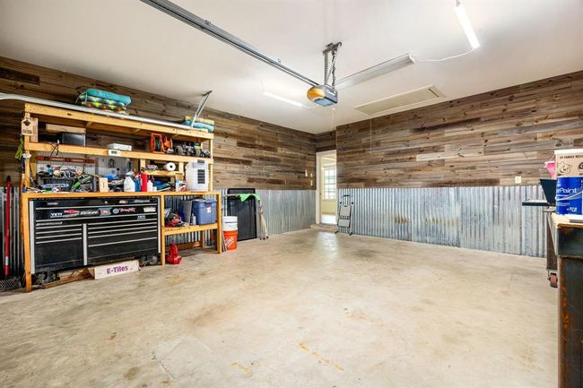 The perfect garage and workspace!! This two car garage comes with custom wall paneling and built in storage. | Image 31