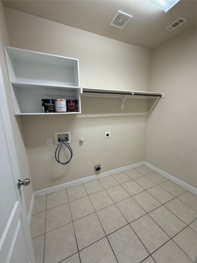 Laundry room with hookup for an electric dryer, hookup for a gas dryer, washer hookup, visible vents, and laundry area | Image 18