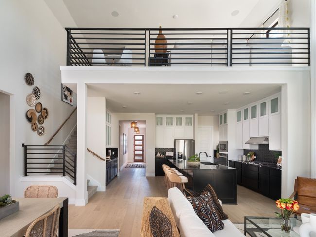 Living area with light wood-type flooring, stairway, and a towering ceiling | Image 5
