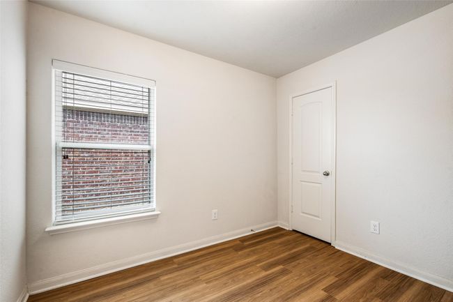 Unfurnished room featuring wood finished floors, plenty of natural light, and baseboards | Image 21