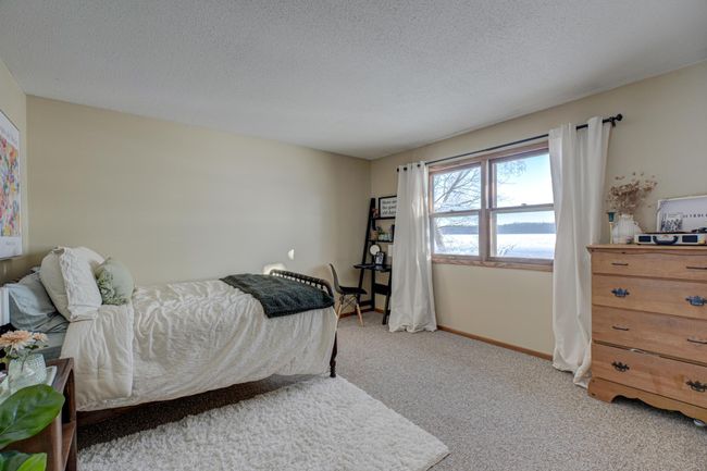 The third bedroom on the main level boasts stunning river views, making it the perfect peaceful retreat | Image 22