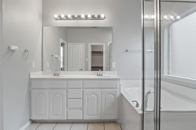 Full bath with double vanity, a bath, and tile patterned floors | Image 32