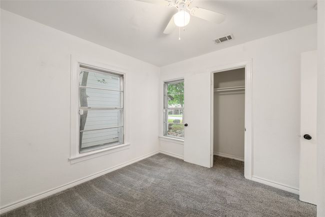 Unfurnished bedroom with carpet floors, baseboards, a closet, and ceiling fan | Image 15