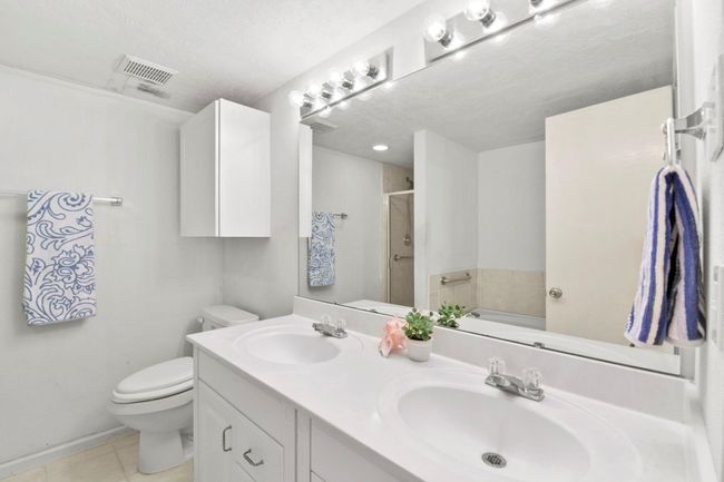 The primary bedroom features double sinks and a spacious soaking tub for ultimate relaxation. | Image 20