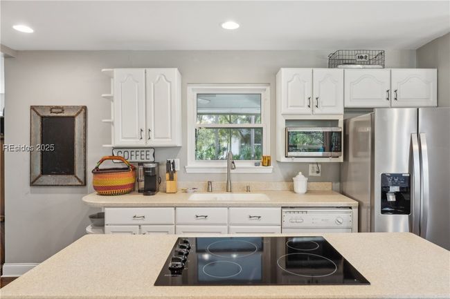 Updated chef's kitchen with stainless steel appliances & ample storage, efficient flow and a window over the sink for a view while prepping and cooking. | Image 19