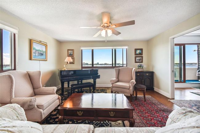 Living room with lots of windows to enjoy the expansive water views. | Image 9