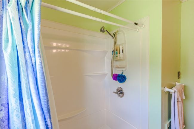 Bathroom featuring a shower with shower curtain | Image 25
