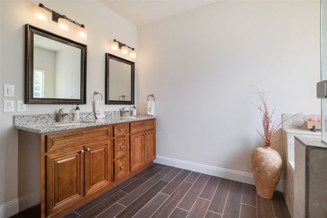 Bathroom featuring dual vanities and a waterfall fixtures. | Image 19