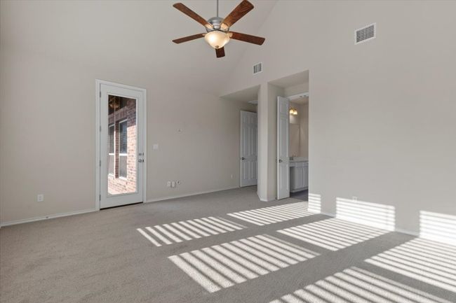 Unfurnished room with high vaulted ceiling, a ceiling fan, and light carpet | Image 11