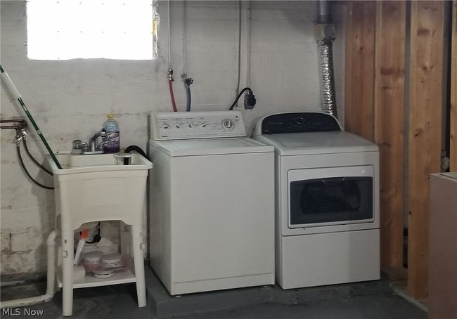Laundry room featuring separate washer and dryer, washer hookup, and hookup for an electric dryer | Image 9