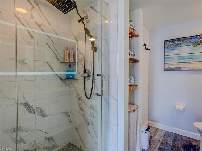 OWNER'S SUITE FULL-HEIGHT TILED SHOWER W/FRAMELESS GLASS DOORS AND RAIN HEAD. | Image 26