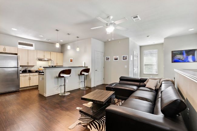 Living room with dark wood-style flooring, recessed lighting, and a ceiling fan | Image 7