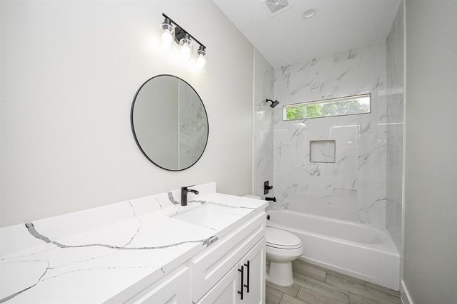 Secondary Bathroom Has Both The Stand-Up Shower & Bathtub Combination. All The Bathrooms Throughout The Home Have The Same Aesthetic Including Quartz Countertops & Mirrors | Image 15