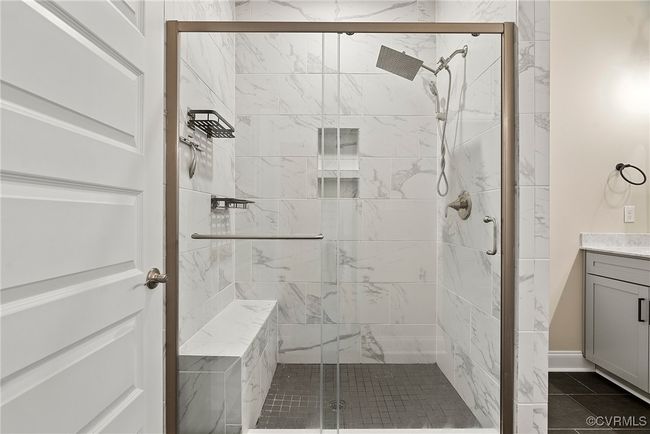 Bathroom with tile patterned flooring, vanity, and a shower with door | Image 14