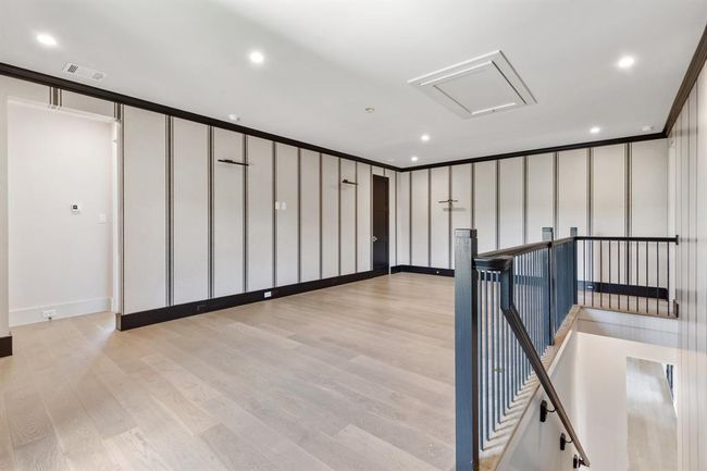 Climb the stairs on the custom runner on top of oak treads to arrive at this game room. Custom wall treatments and sumptuous textures beckon all guests to relax and unwind. A large closet offers storage solutions and this serves as a hub between the two guest bedrooms on the second floor. | Image 27