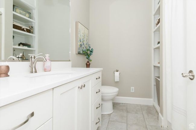 Bathroom featuring baseboards, vanity, and toilet | Image 47