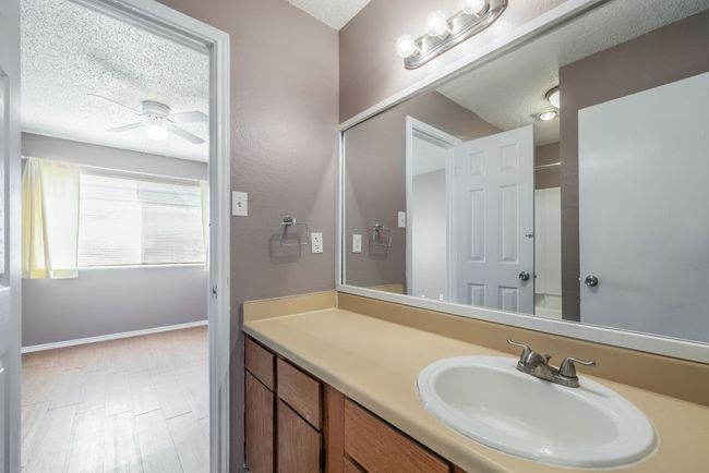 Bathroom with a textured ceiling, vanity, and ceiling fan | Image 25