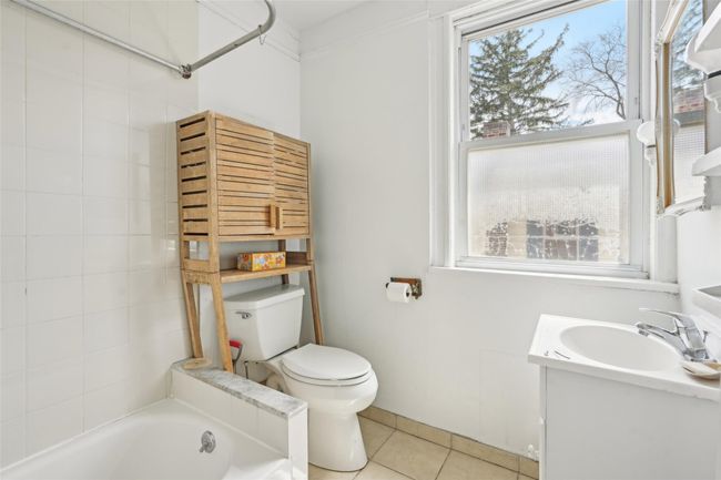 Full bathroom featuring toilet, a tub to relax in, tile patterned floors, and plenty of natural light | Image 24