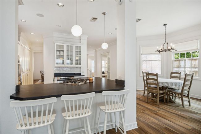 Open concept kitchen with counter height seating. | Image 8
