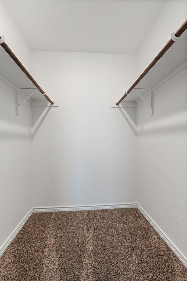 Walk in closet featuring carpet | Image 25