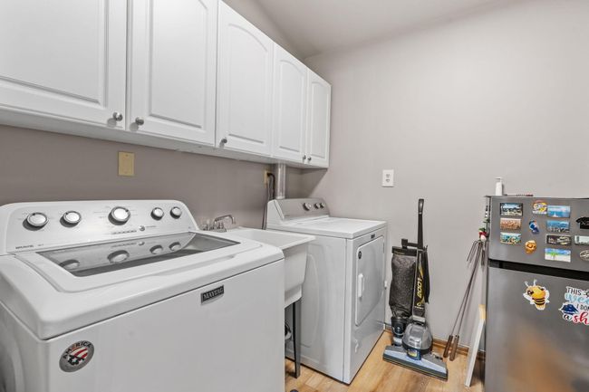 You'll love having laundry on the main level! Laundry sink too and space for storage | Image 23