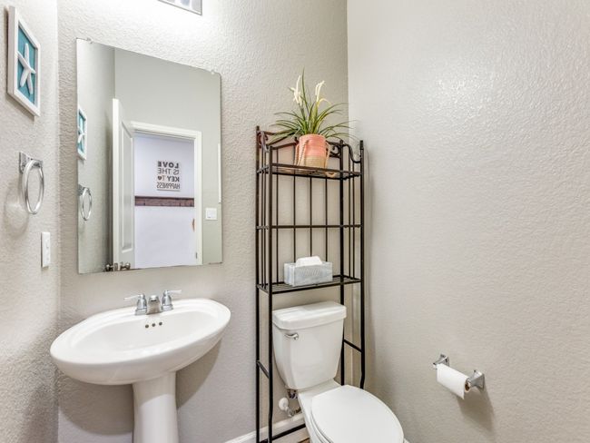Half bathroom featuring toilet and a textured wall | Image 16