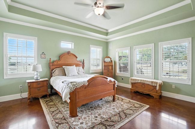 Bedroom featuring multiple windows, ornamental molding, and a ceiling fan | Image 14